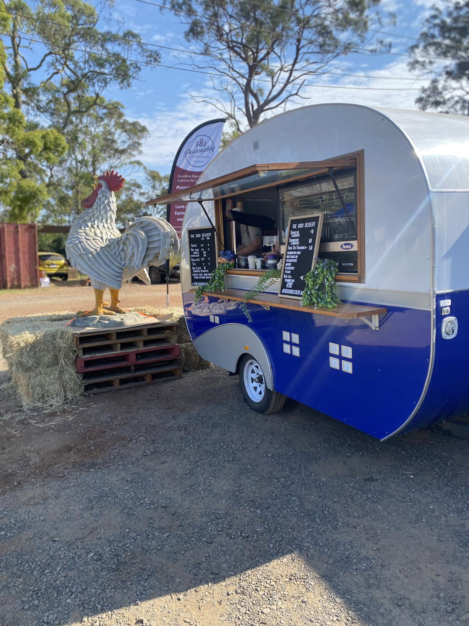 Highfields Produce farm store outdoor scene with hay bales and a rural caravan stall