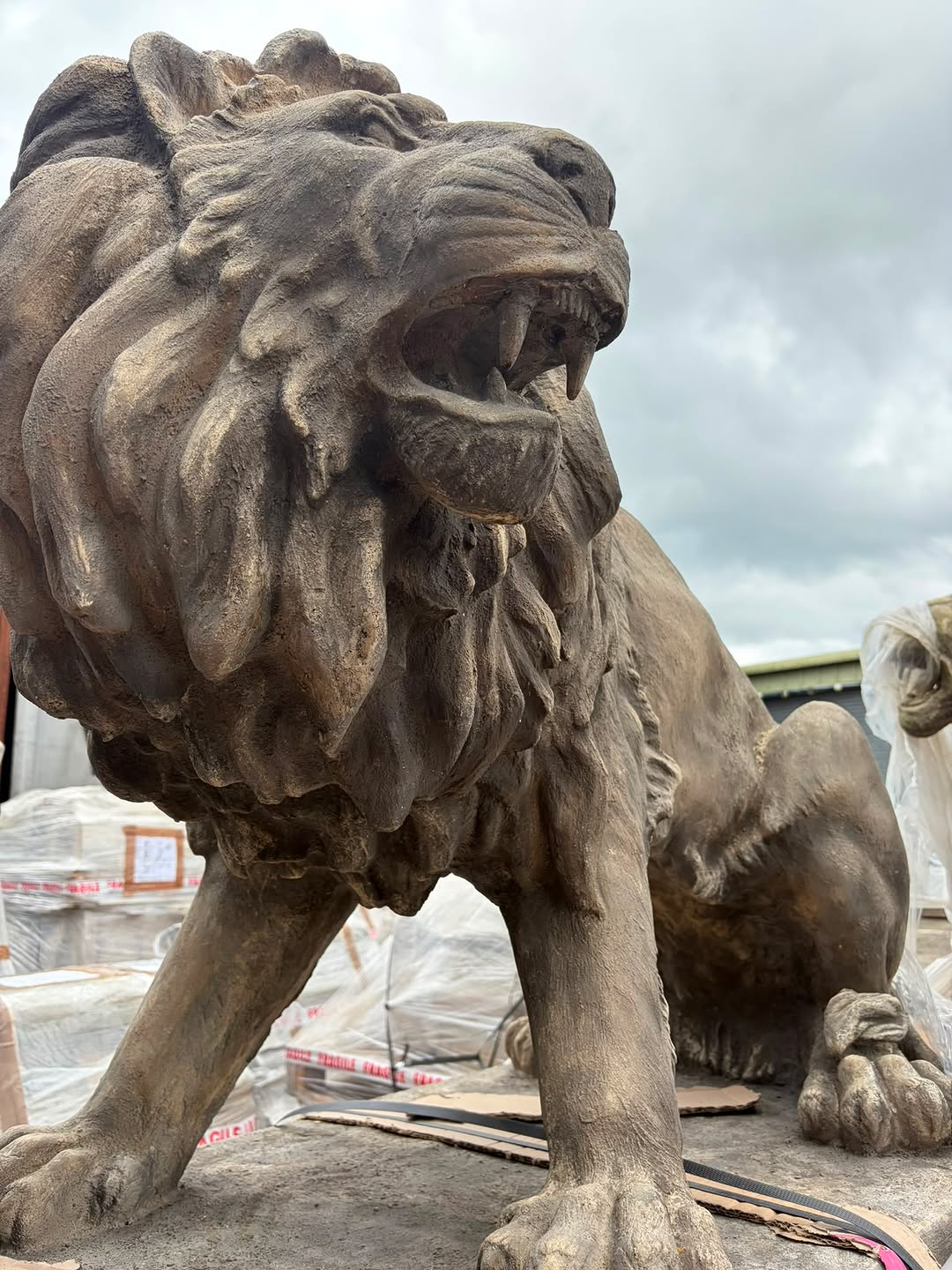 Antique stone lion statues — an example of the historical and collectible items available at Wilson's Salvage Yard