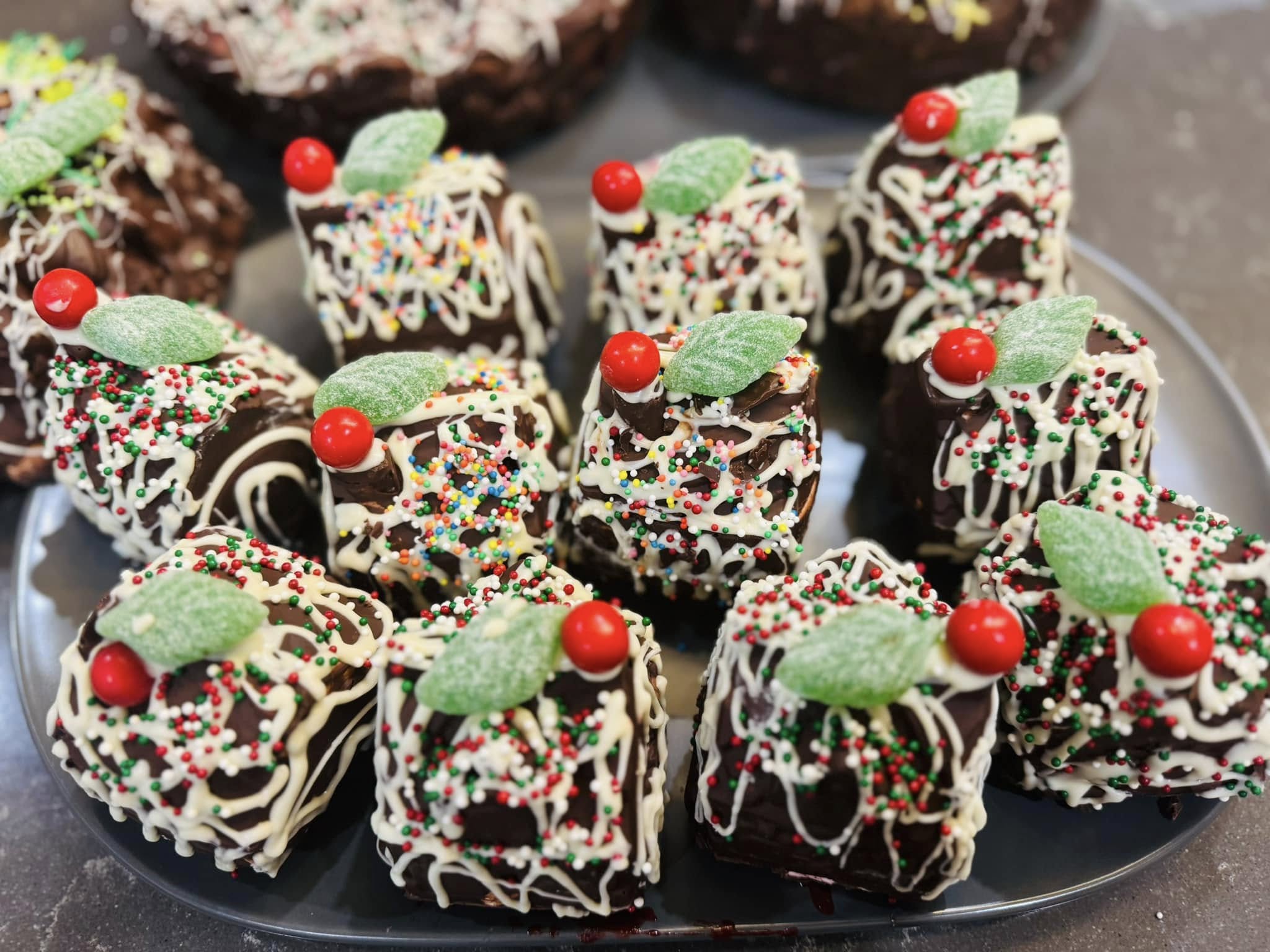 Chocolate slices drizzled with white chocolate and topped with sprinkles and lollies