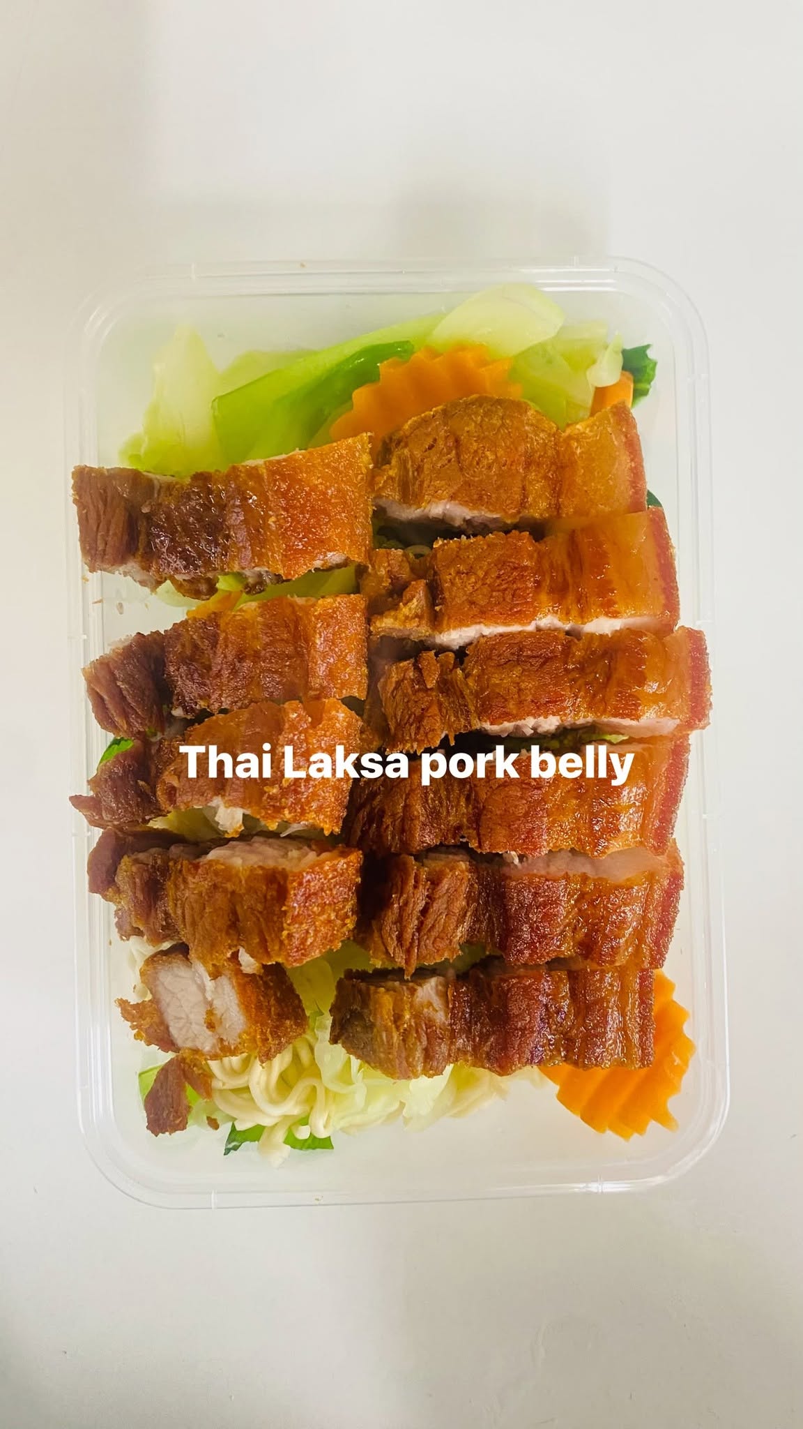 Thai laksa noodle salad with pork belly and fresh vegetables