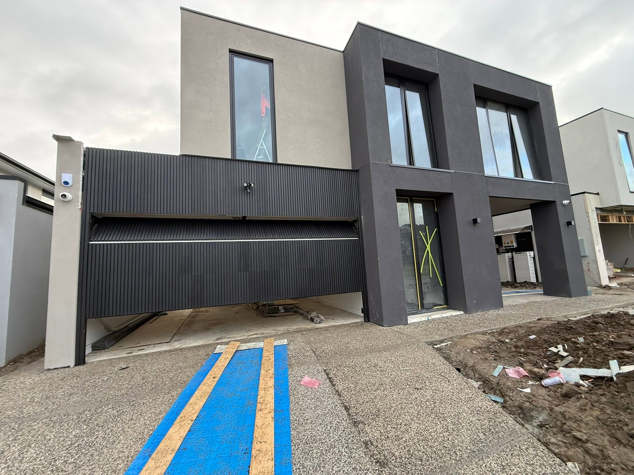 Modern home with a newly installed dark garage door