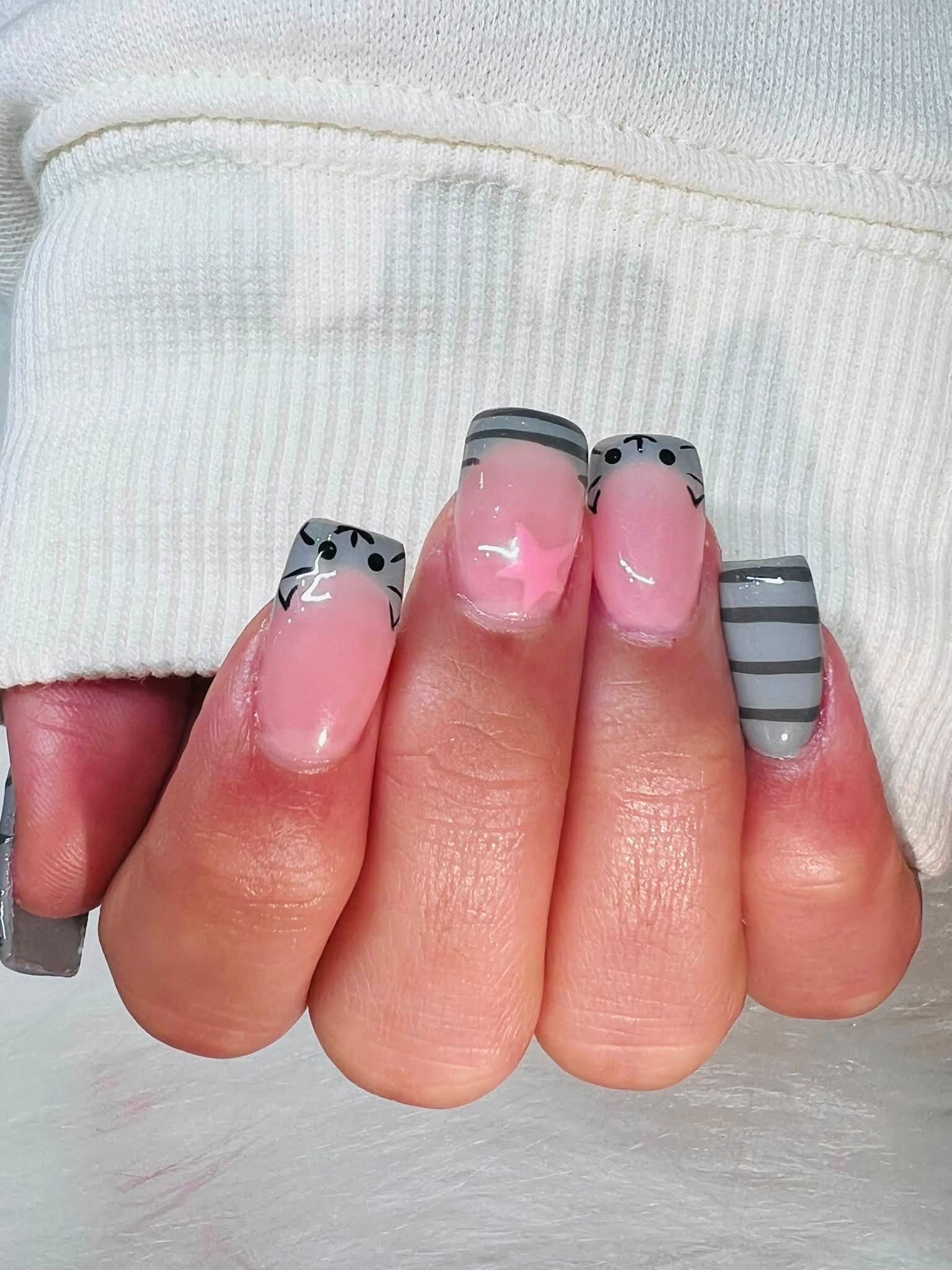 Grey striped nail art with pink star accent