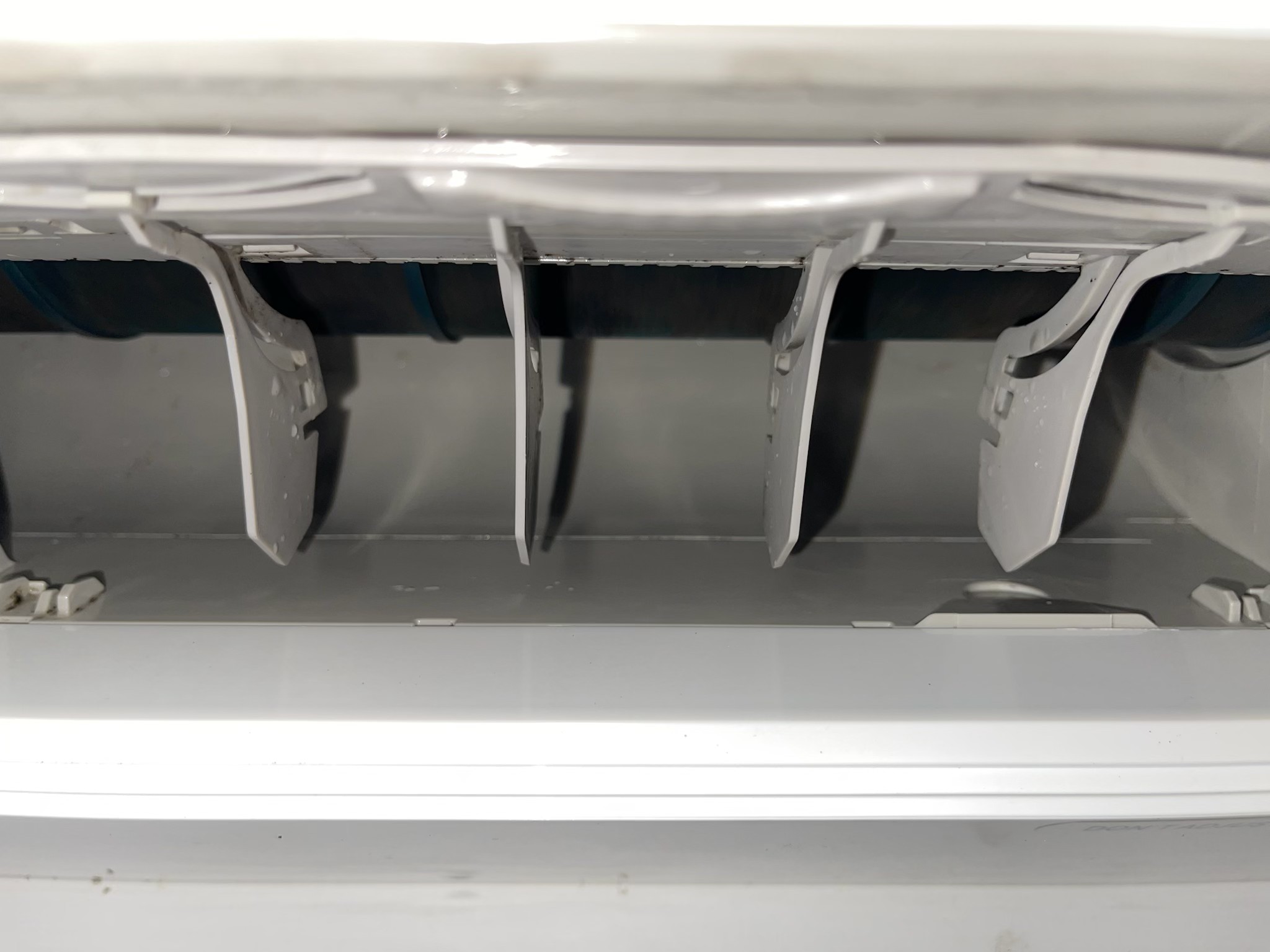 Interior of a clean air conditioning unit showing fins and components after servicing