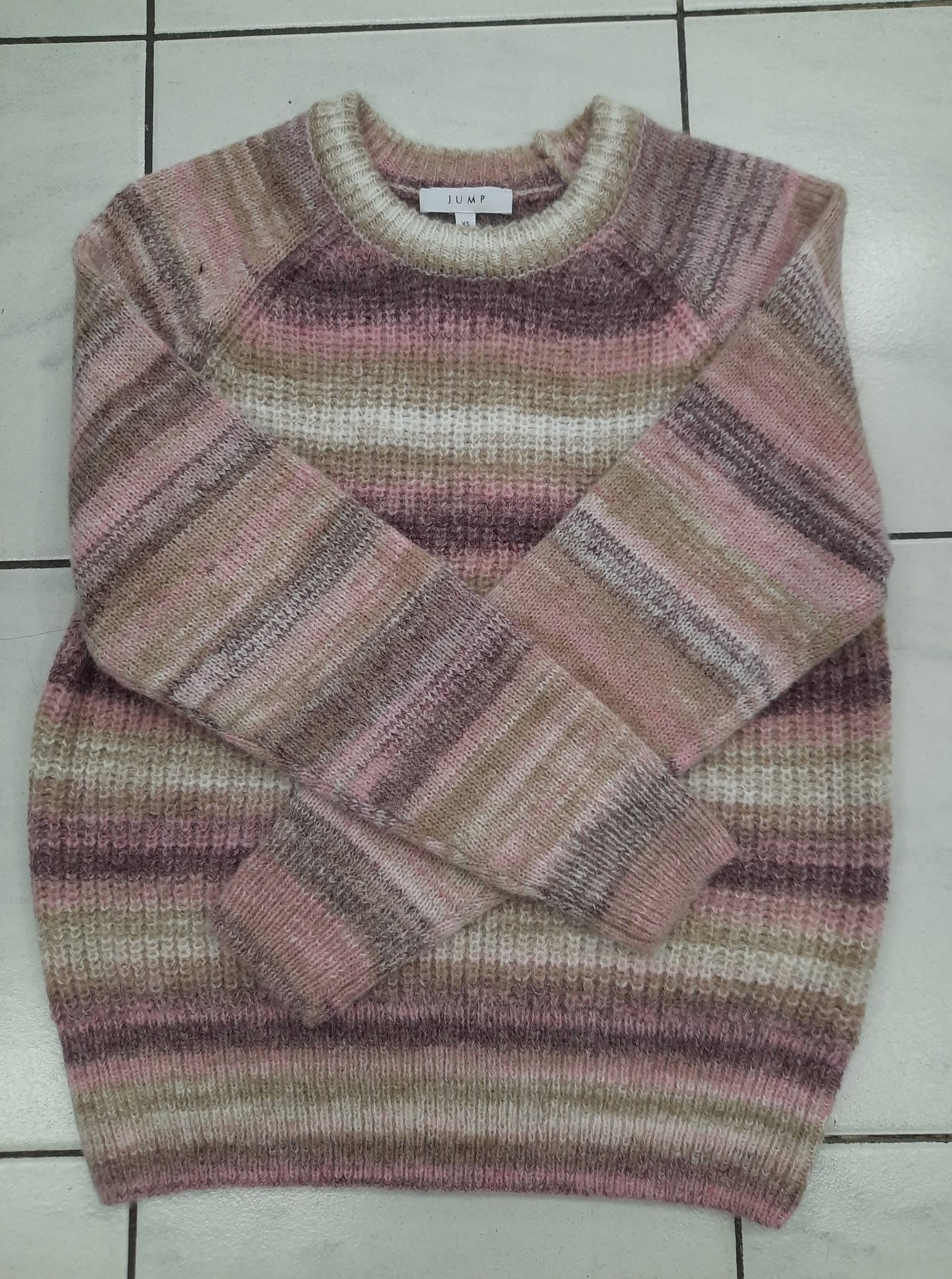 Soft pink V-neck knit jumper laid flat