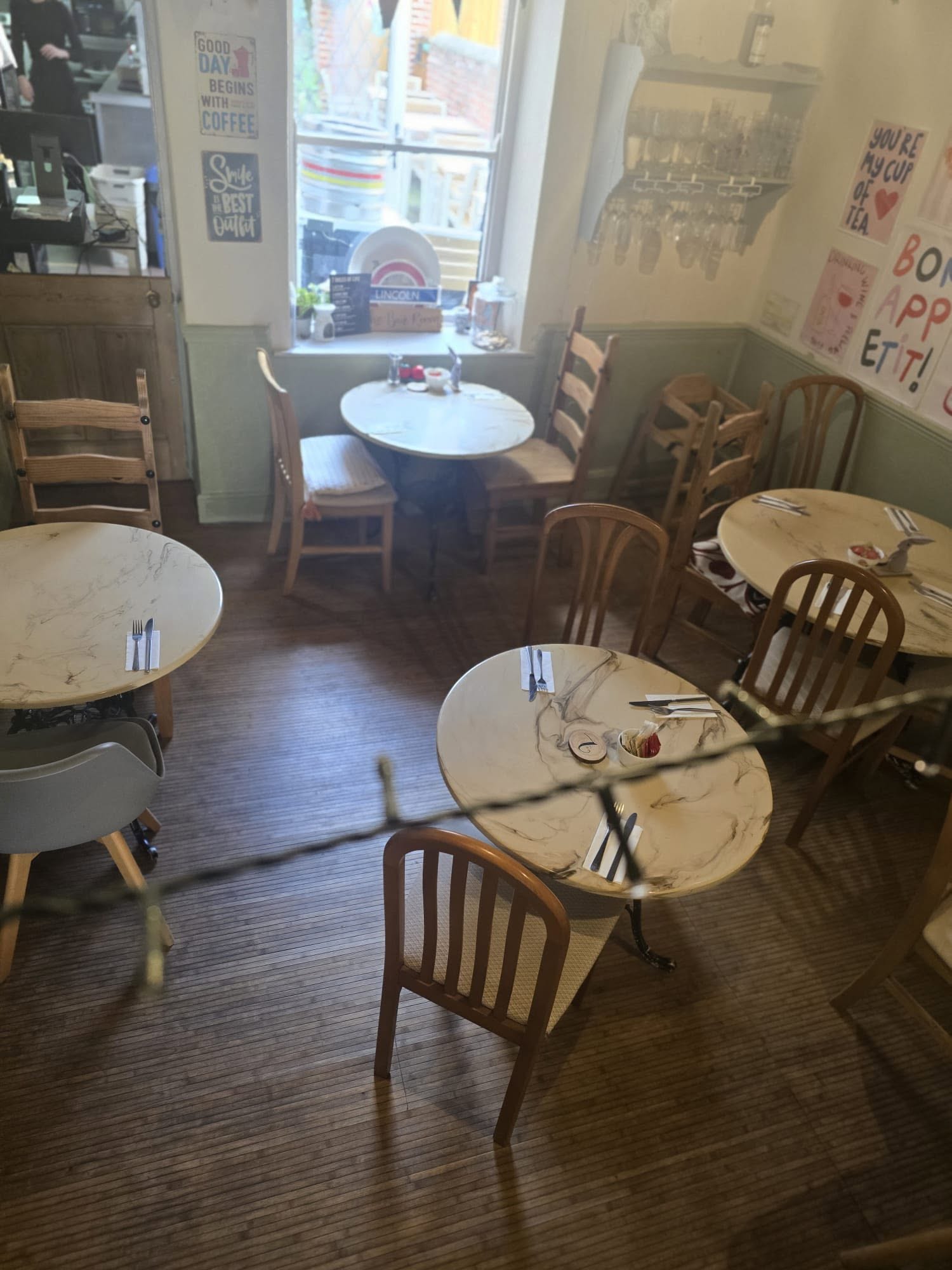 Jiji Bistro & Bar dining room with marble-topped tables and warm natural light