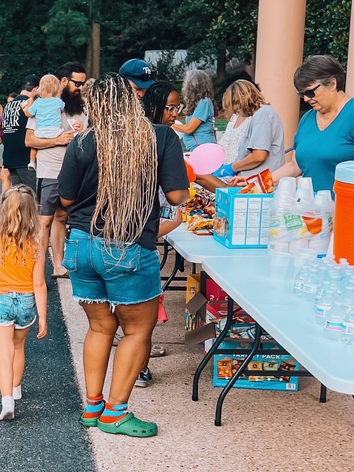 Community gathering around a snack table at a church event
