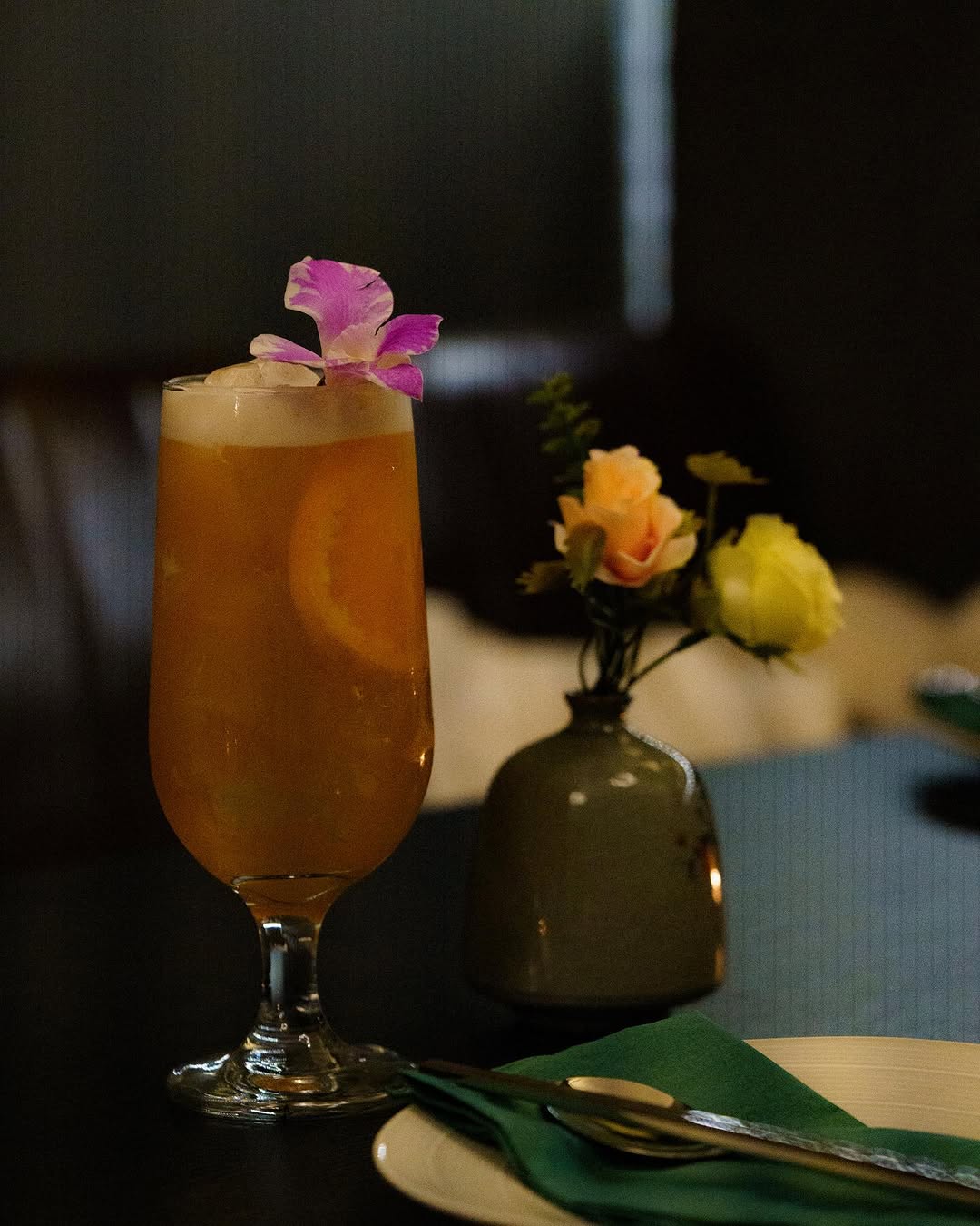 Iced tea with flower garnish on a candlelit table at Chef Chen Hawthorn