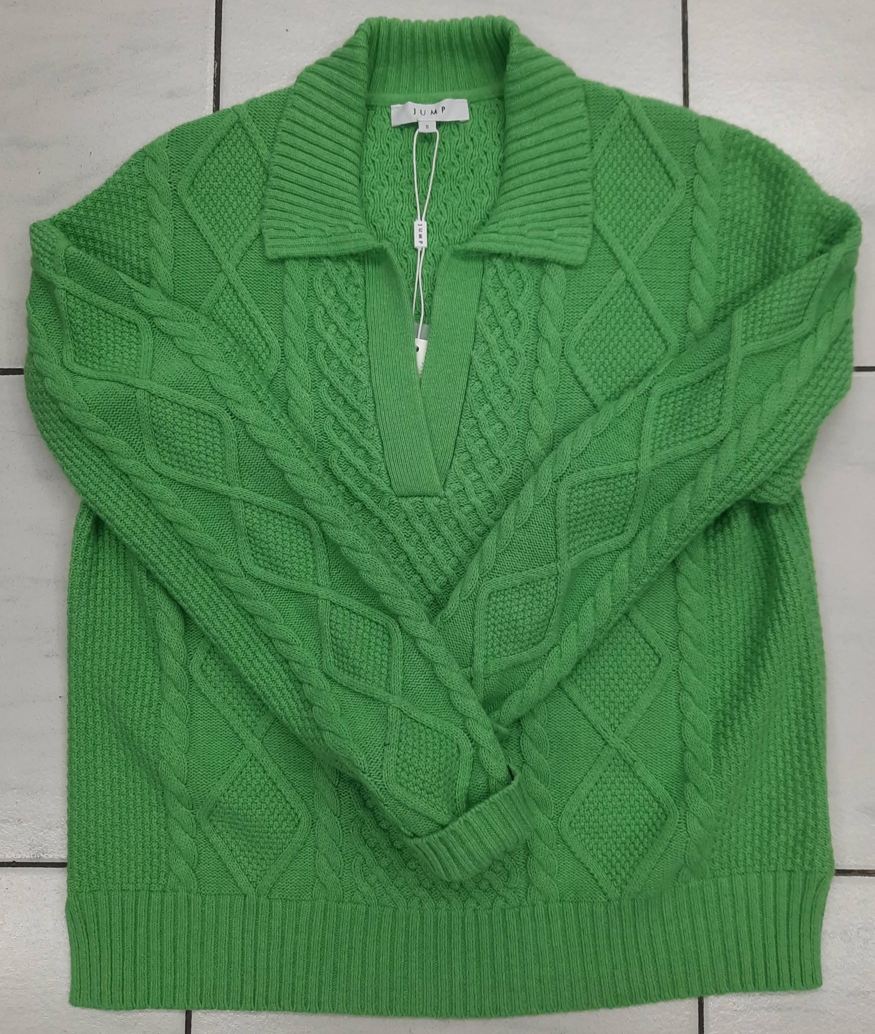 Light green cable-knit polo jumper laid flat