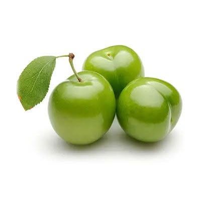 Fresh green plums on a white background