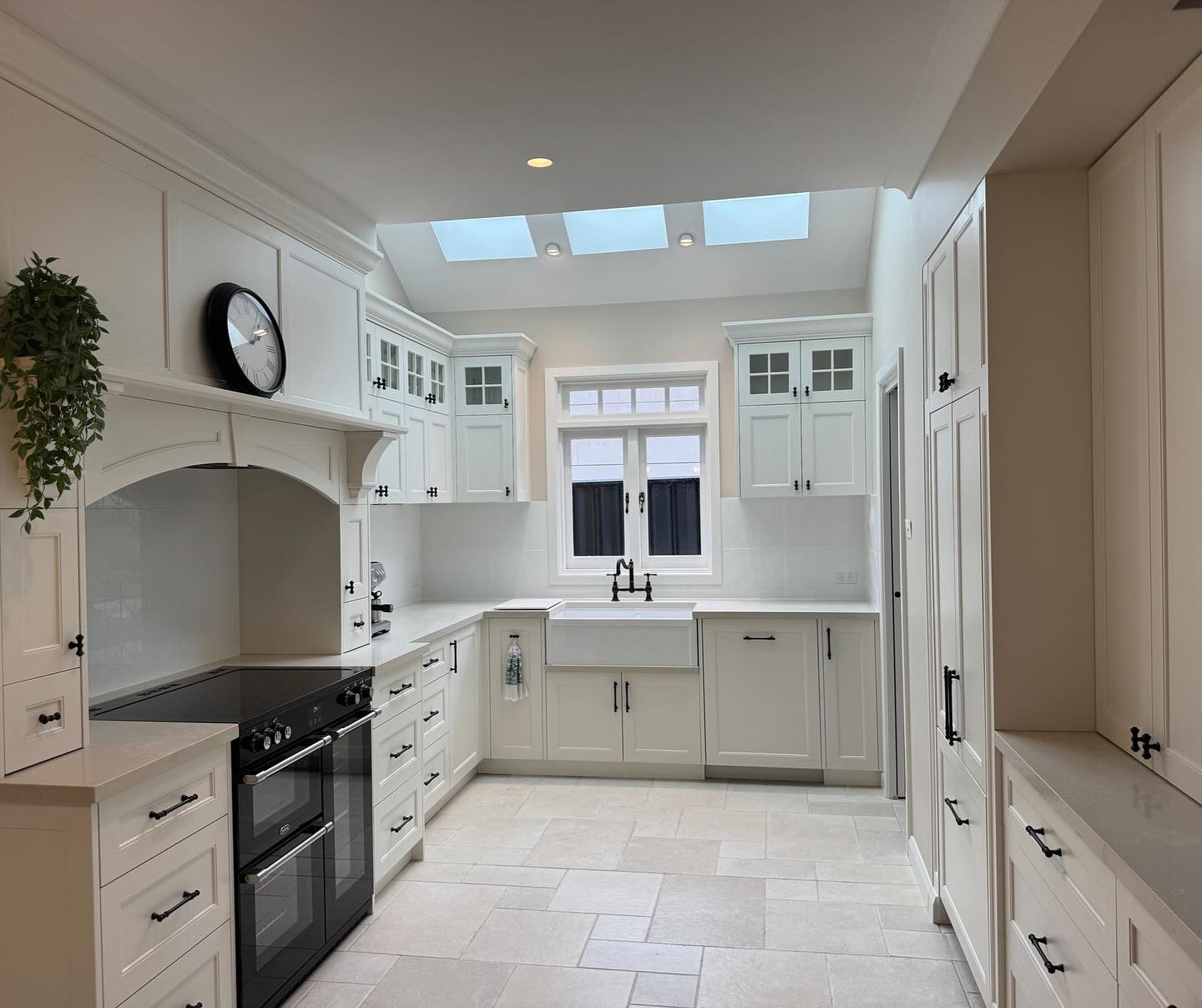 Newly built custom home kitchen by Nelson Constructions with skylight, white shaker cabinetry and stone benchtops
