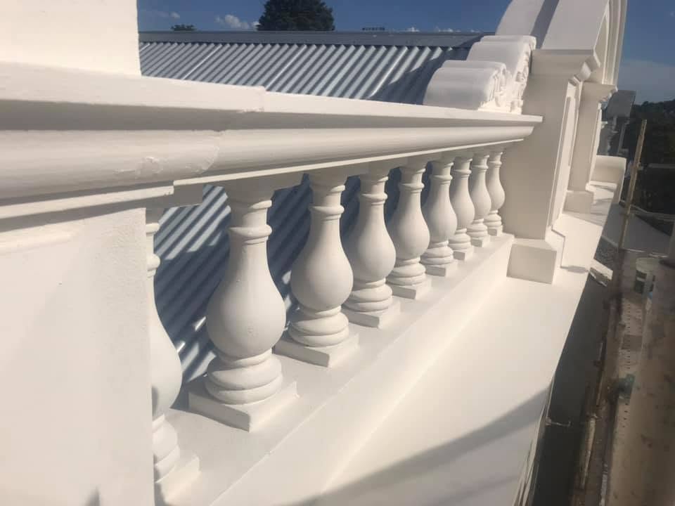 Freshly painted white ornate balustrade row — plastering work by Primo Property Maintenance