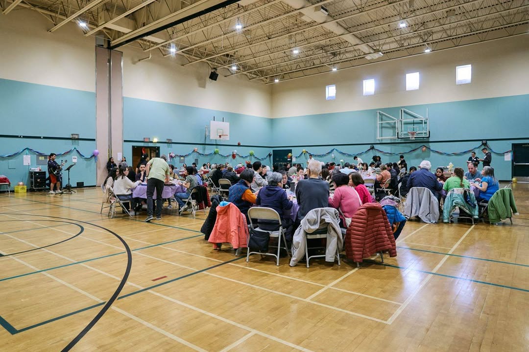 Diverse community gathering for a shared lunch at Collingwood Neighbourhood House