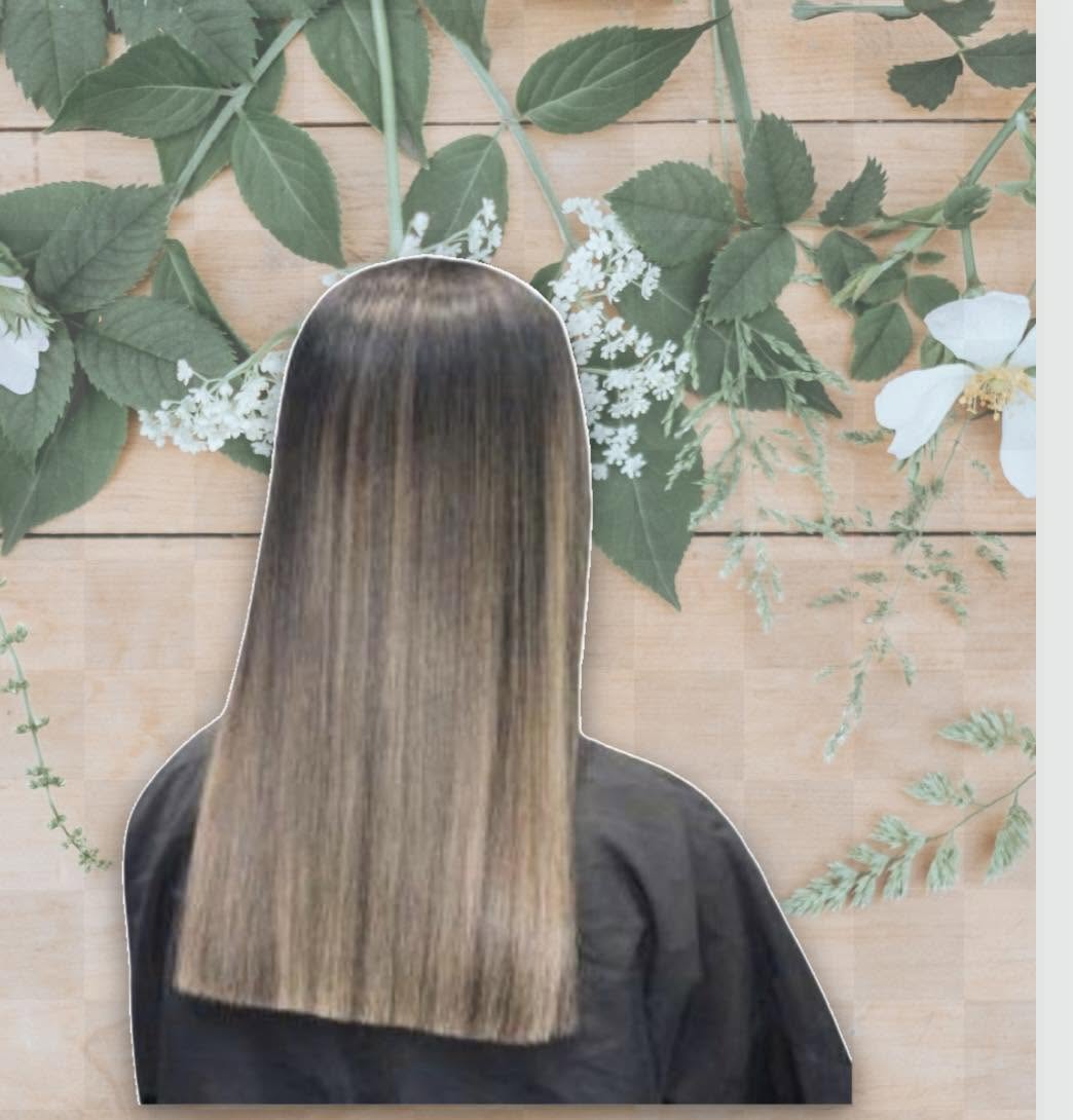 Sleek straight hair with a soft blonde ombre finish on a floral backdrop