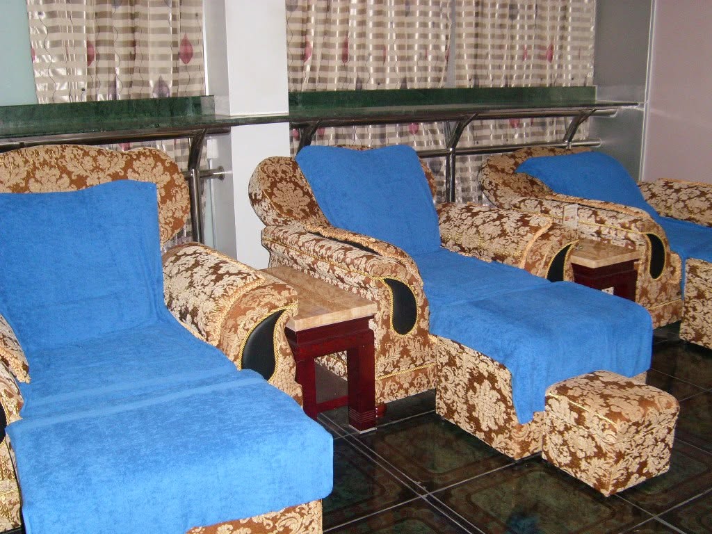 Comfortable foot massage recliner chairs arranged in the spa treatment room