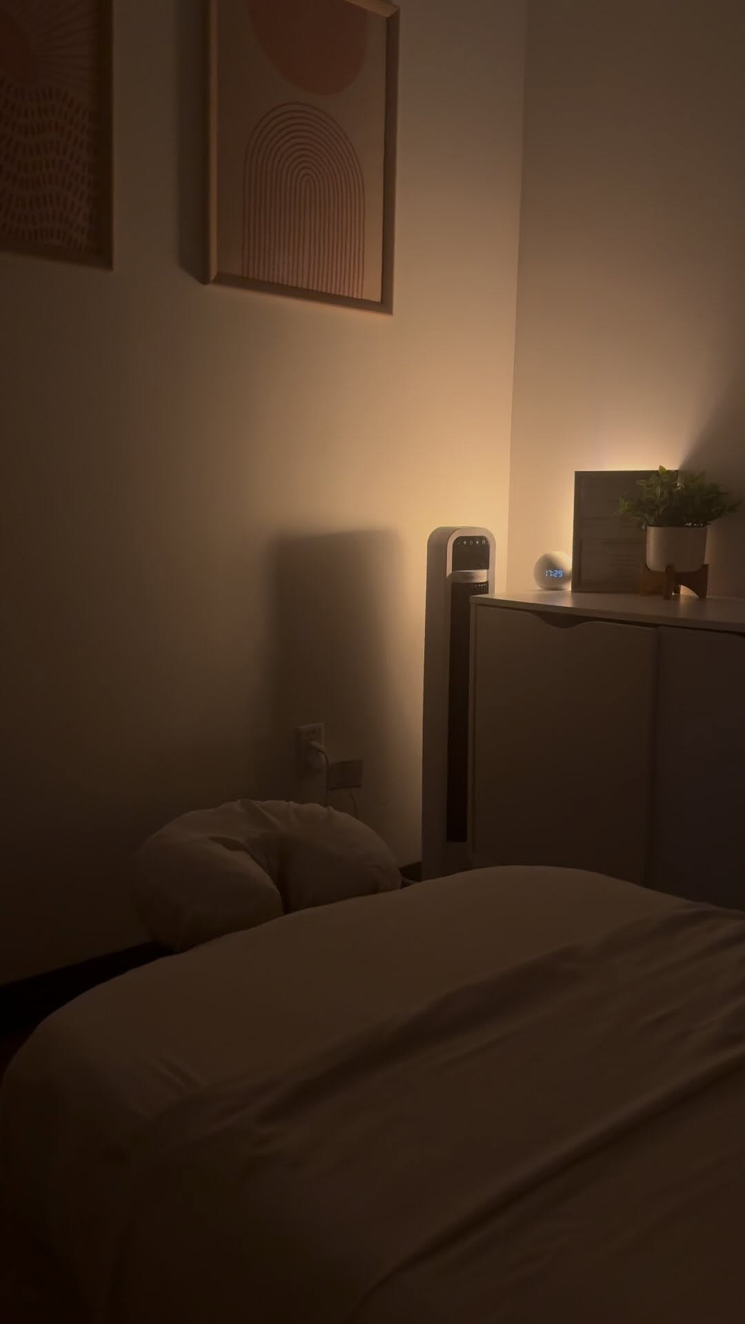 Cosy amber-lit treatment room with geometric art and massage table at Zen Tara Mentone