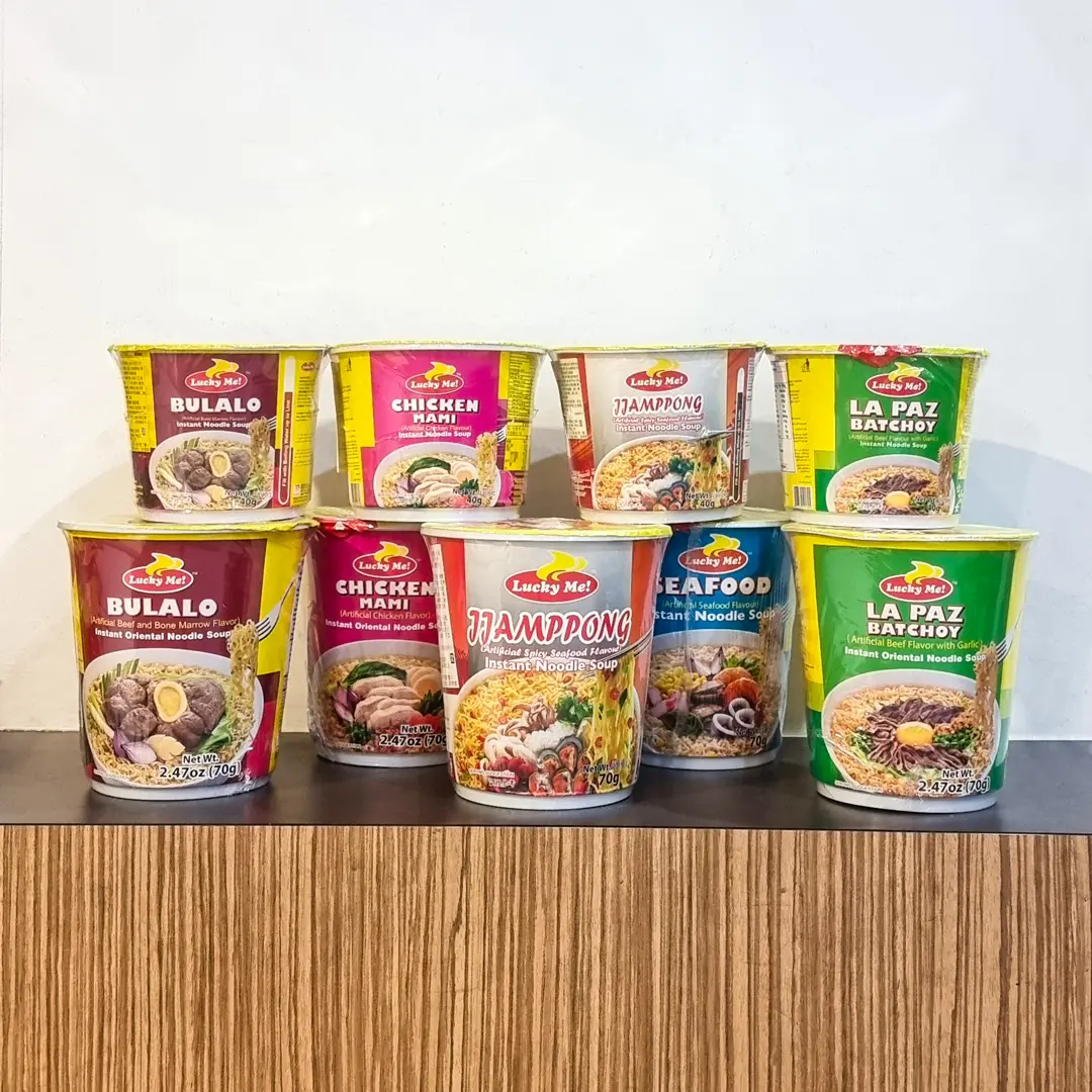 Stacked cups of Lucky Me instant noodle soup in several flavours