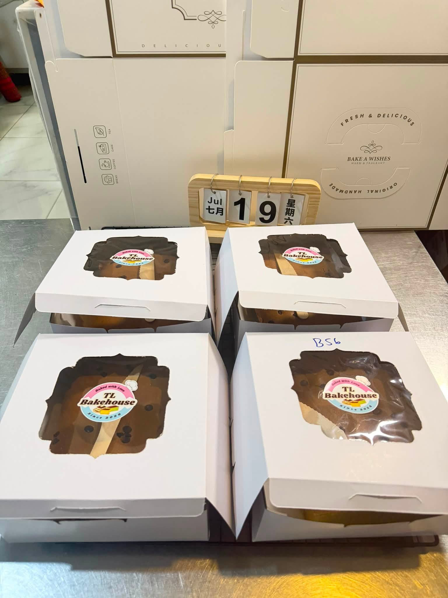 Four TL Bakehouse gift boxes with window-display cakes