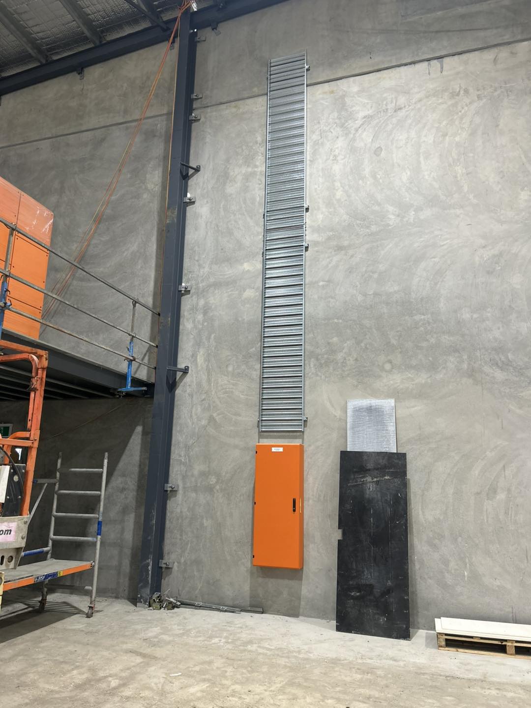 Commercial electrical switchboard and cable tray installation in a warehouse