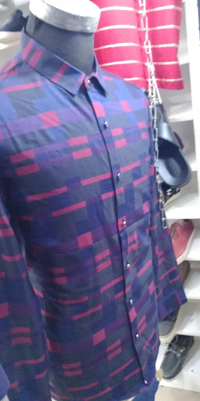 Patterned navy and red button-up shirt on a mannequin in a clothing shop