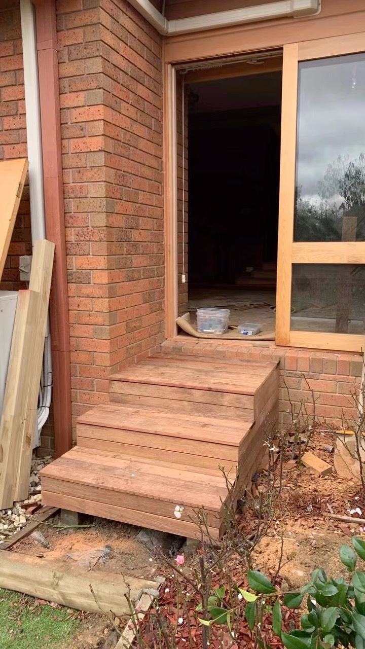 New timber deck steps built at the entrance of a brick home