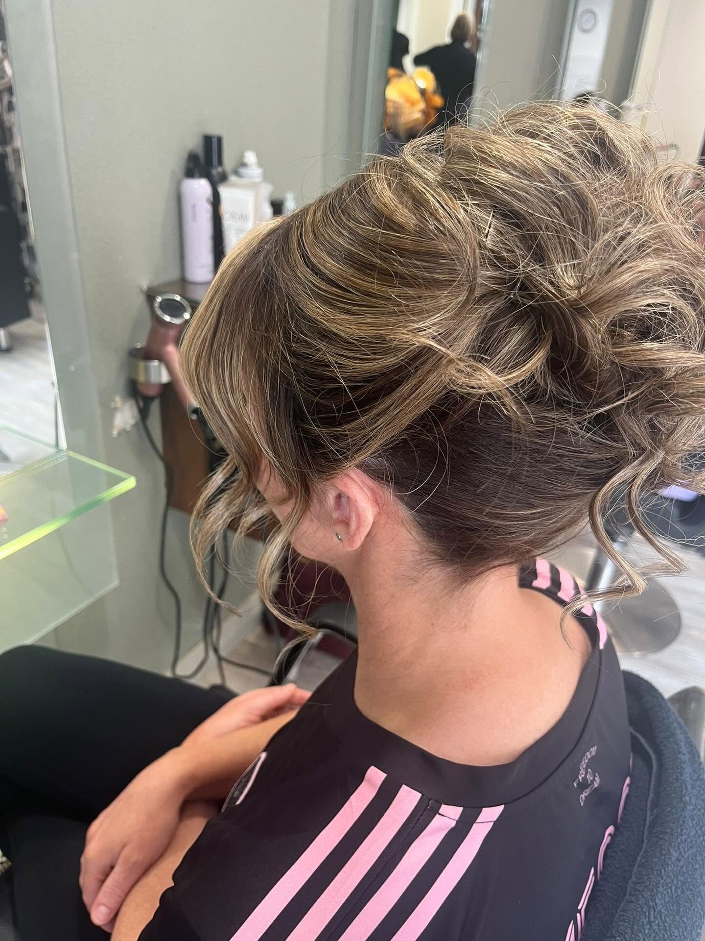 Brunette updo with highlighted tendrils