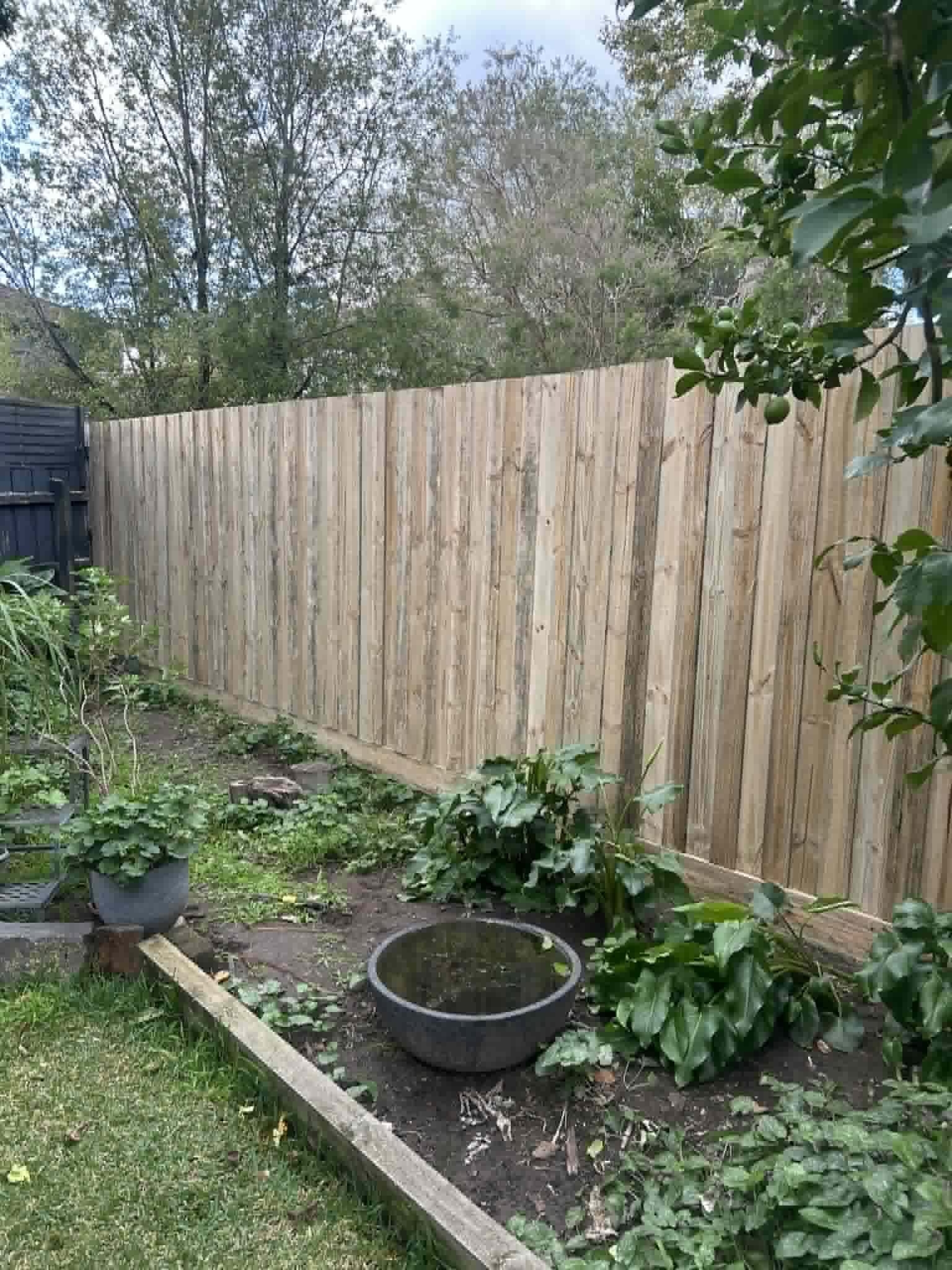 Timber security fence installation in a garden setting by K and Co Fencing