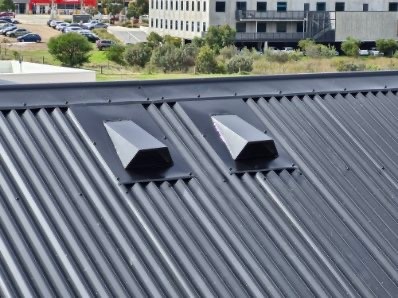 Roof ventilation caps fitted on a dark Colorbond corrugated roof
