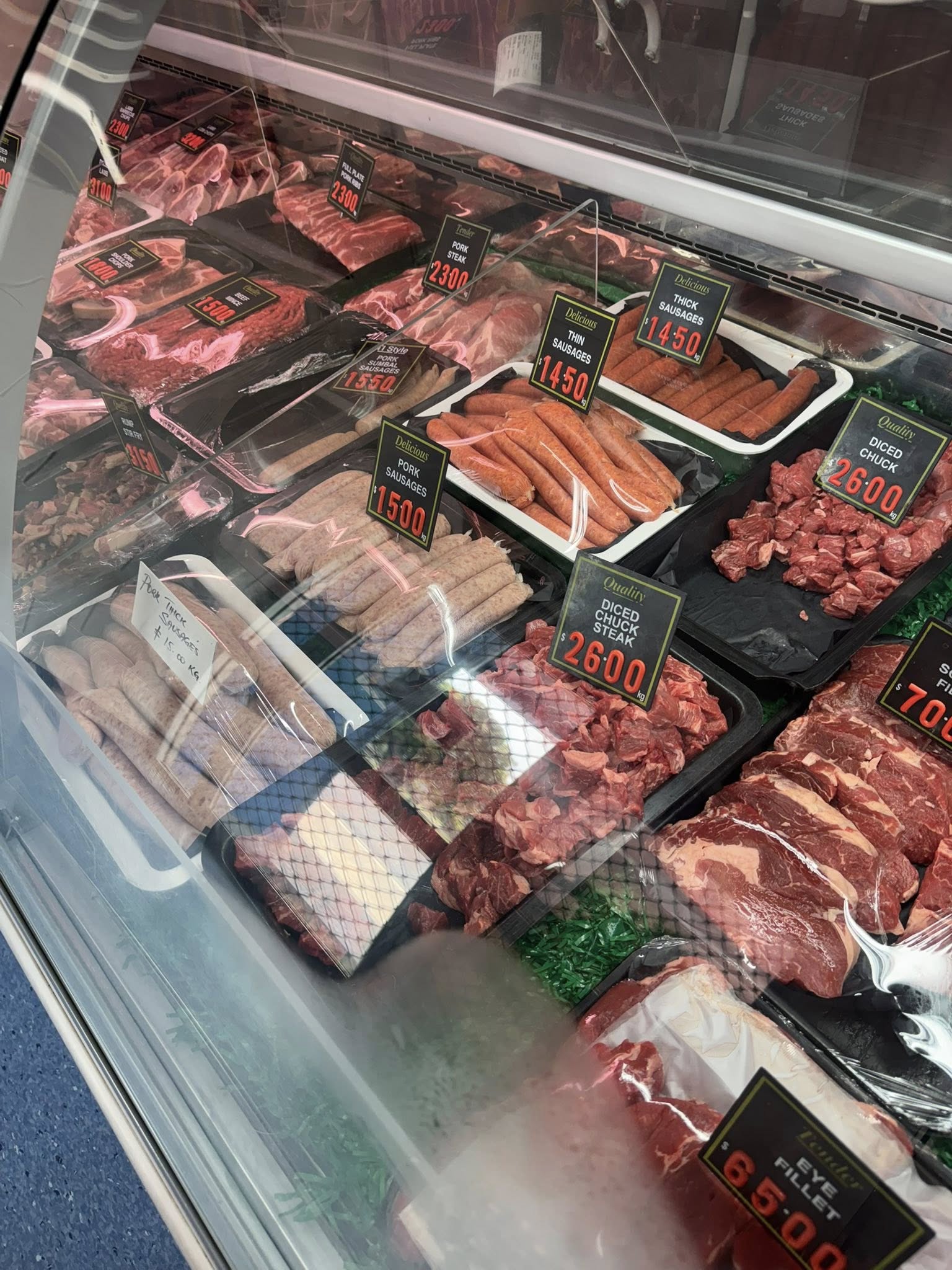 Pork sausages, thin sausages and thick sausages in the deli display cabinet