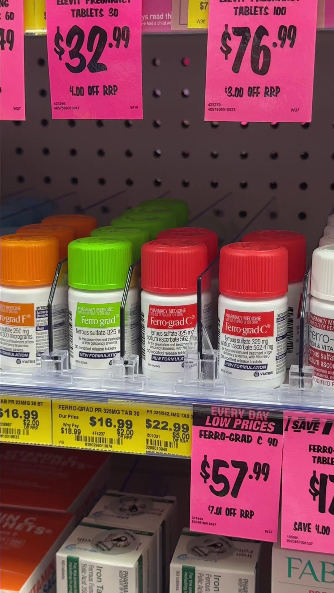 Pharmacy shelves stocked with iron supplement tablets including Ferro-grad range, showing everyday low prices at Direct Chemist Outlet