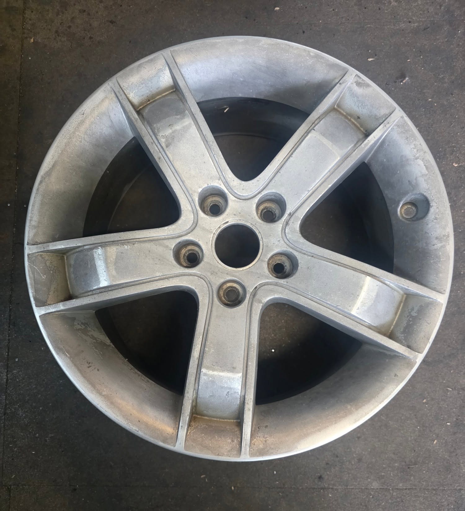 Close-up of a restored alloy wheel with polished machined barrel surface