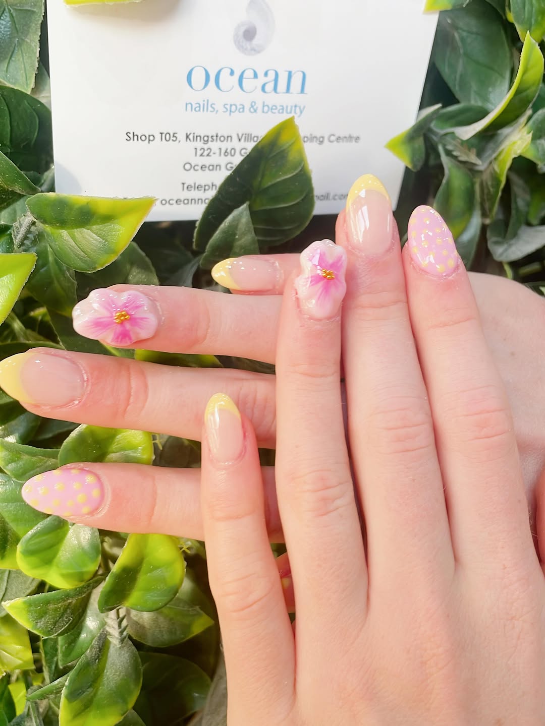Yellow and pink French tip nails with 3D flower art