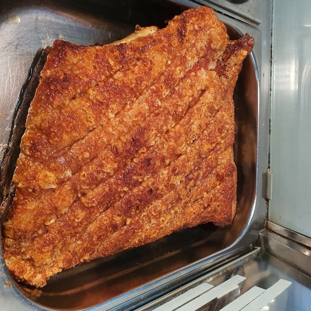 Freshly roasted Vietnamese pork belly with golden crackling skin at Mountain Gate Hot Bake House