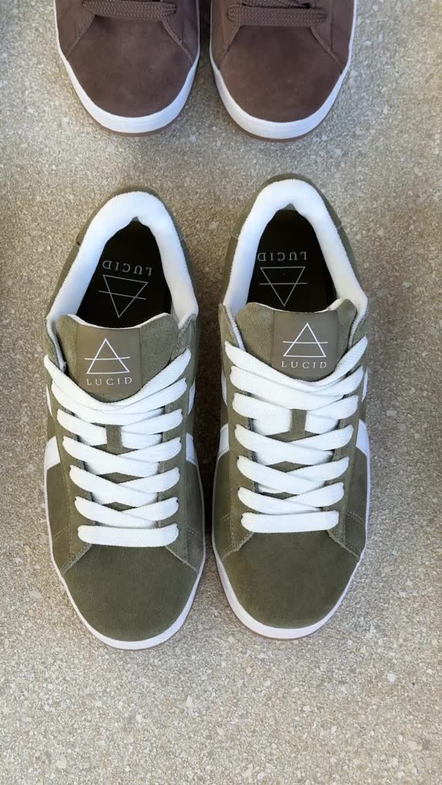 Lucid brand olive suede sneakers with white laces viewed from above on concrete
