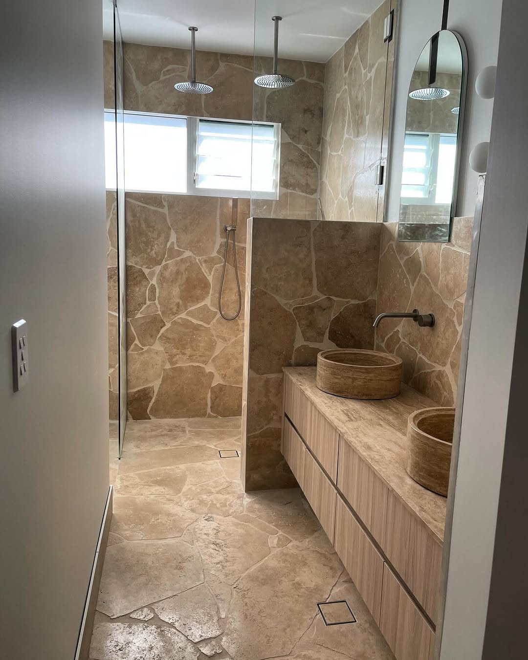 Natural stone tiled bathroom renovation completed in Brisbane