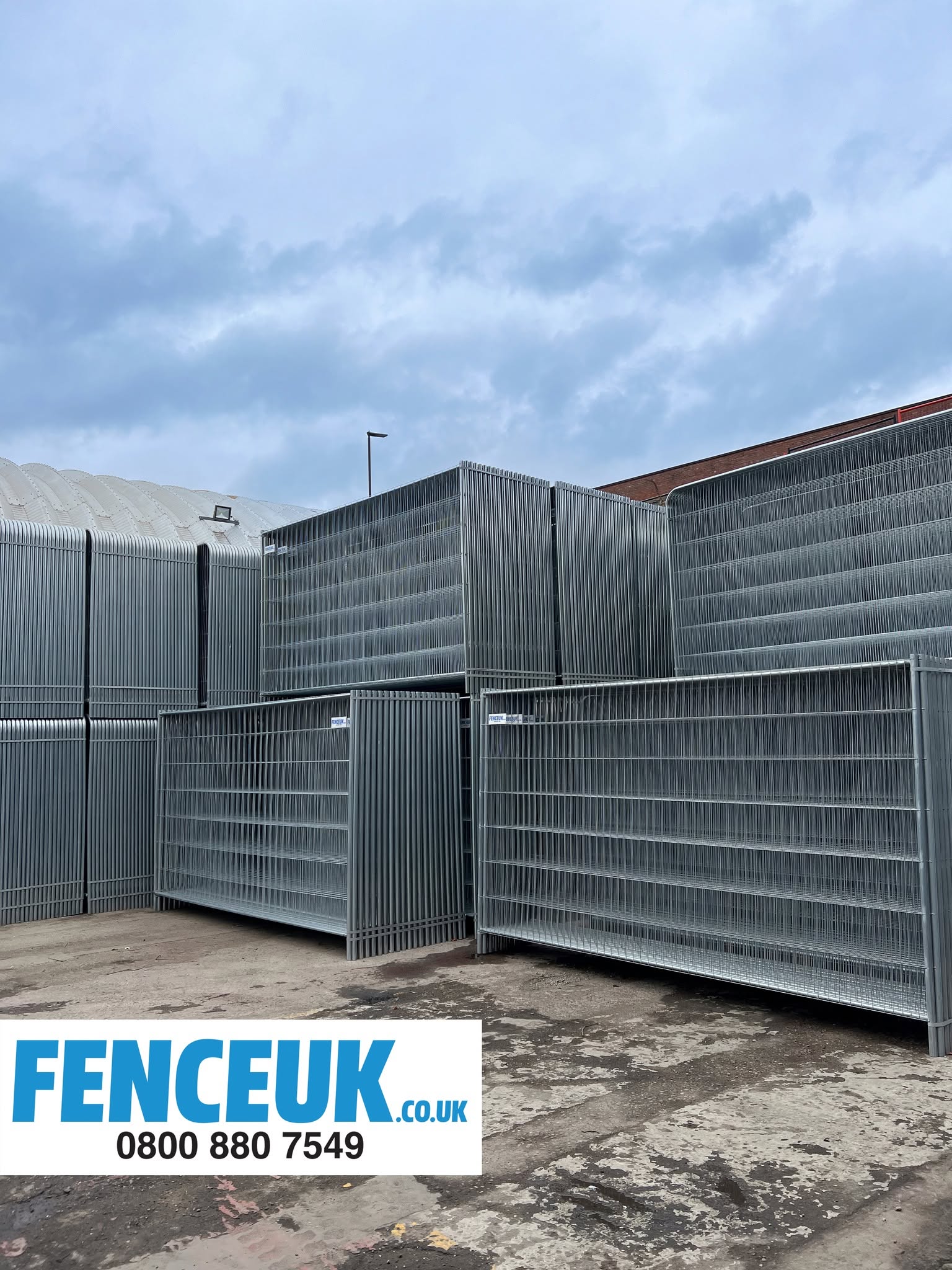 Tall steel palisade fence panels stacked and ready for installation