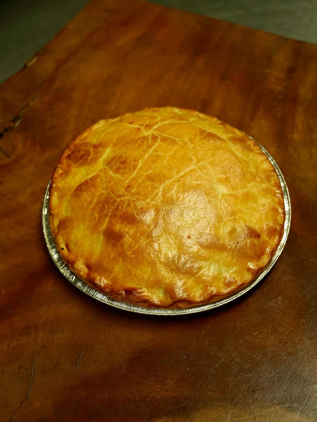 Golden pastry pie in a round foil dish – an example of Apple Pip Catering Co heat-and-eat meal