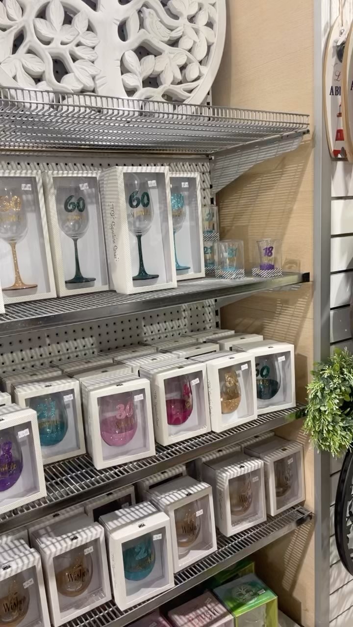 Decorative glassware and gift boxed drinkware displayed on store shelves
