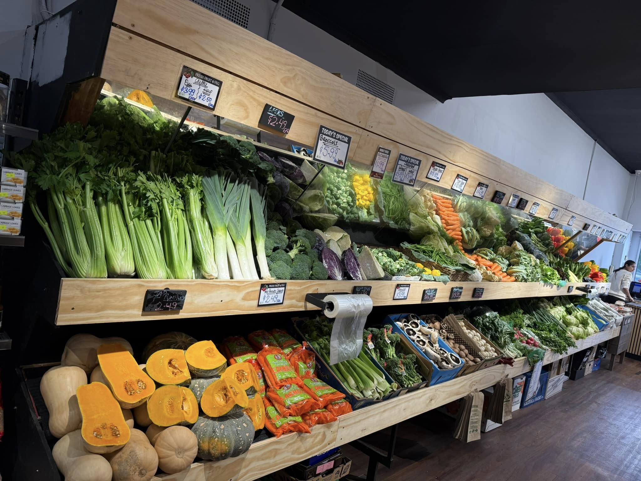 Large vegetable wall display showing pumpkins, celery, broccoli and seasonal vegetables