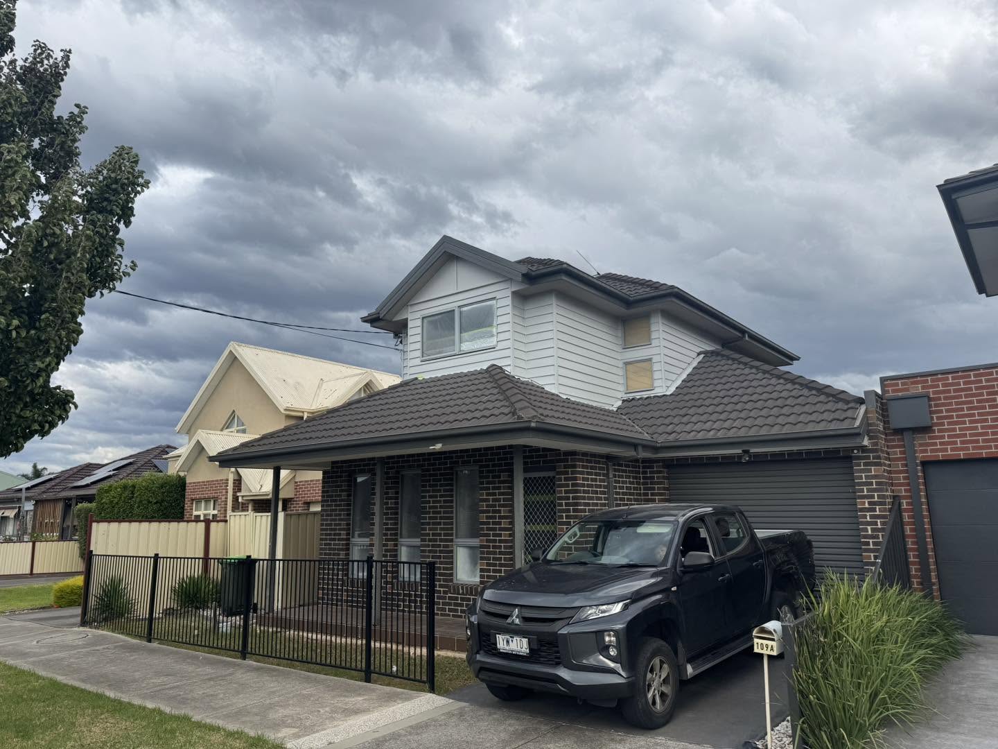 Two-storey brick and weatherboard home freshly painted exterior