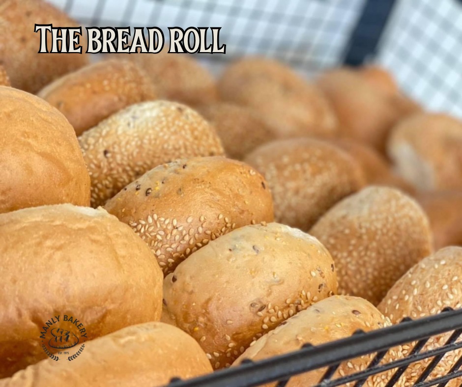 Basket of freshly baked sesame seed bread rolls at Manly Bakery