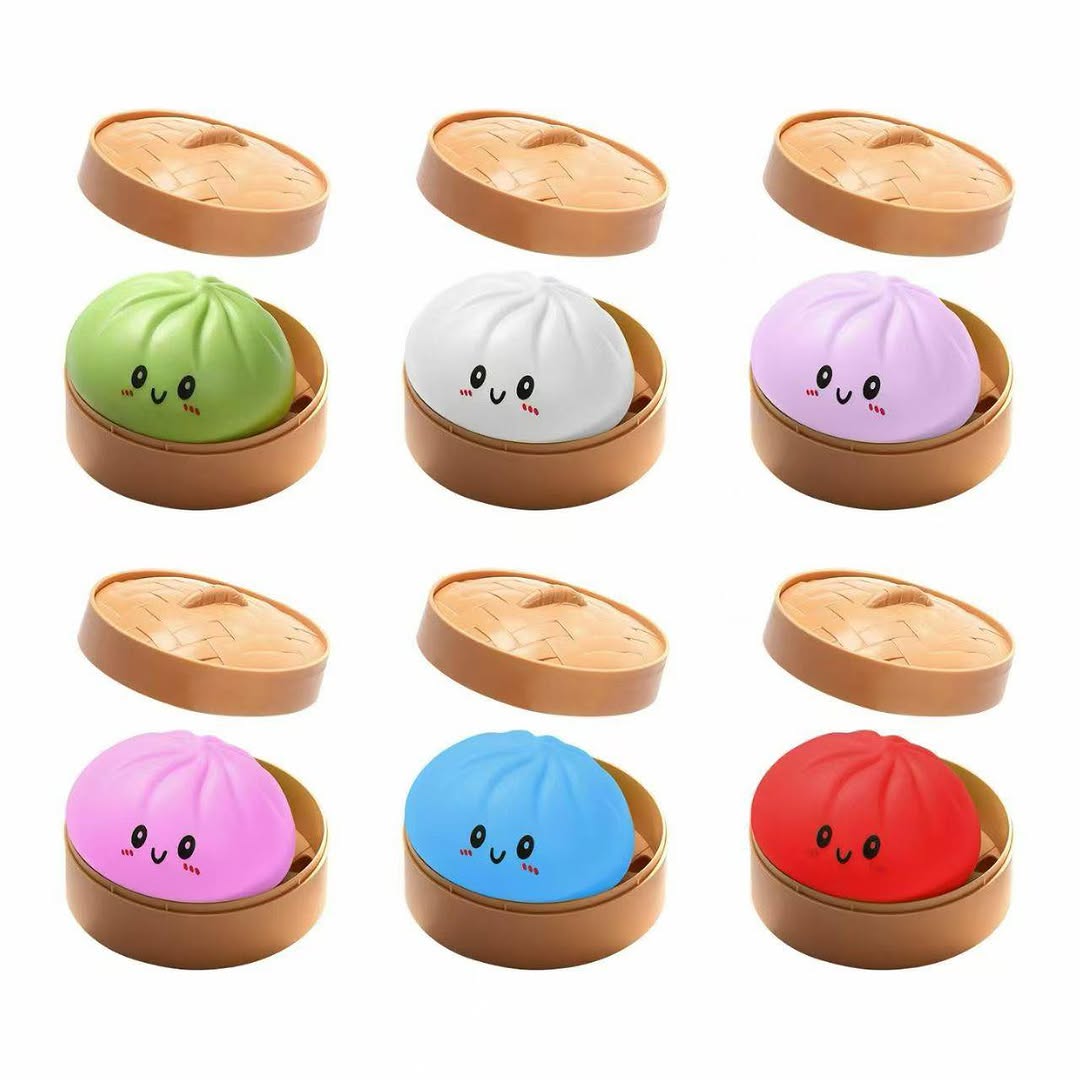 Colourful kawaii dumpling collectible toys in bamboo steamer packaging on white background