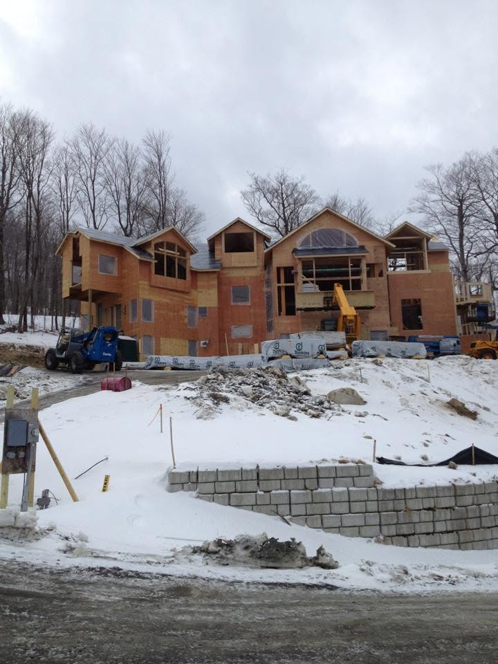 Residential construction site with framing and retaining wall
