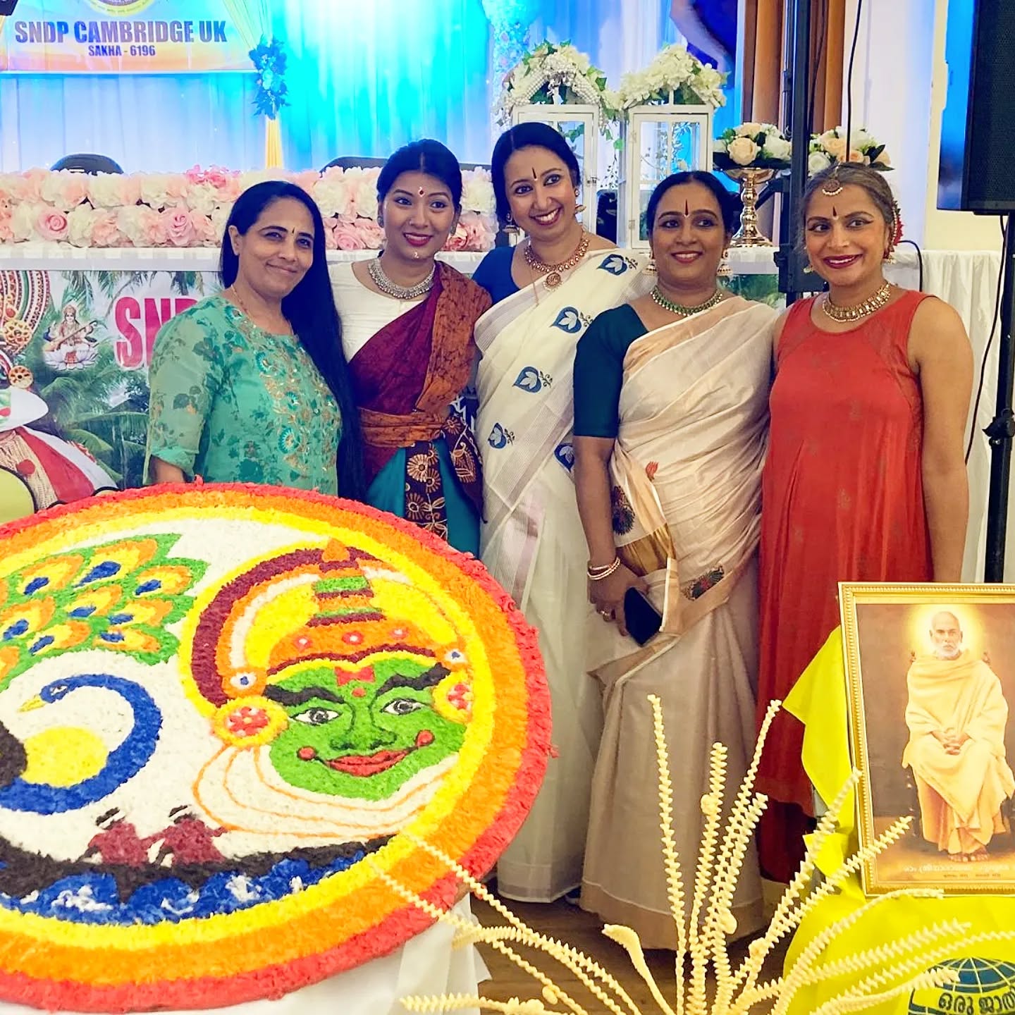 Bharatanatyam performers on stage under colourful blue and yellow lighting