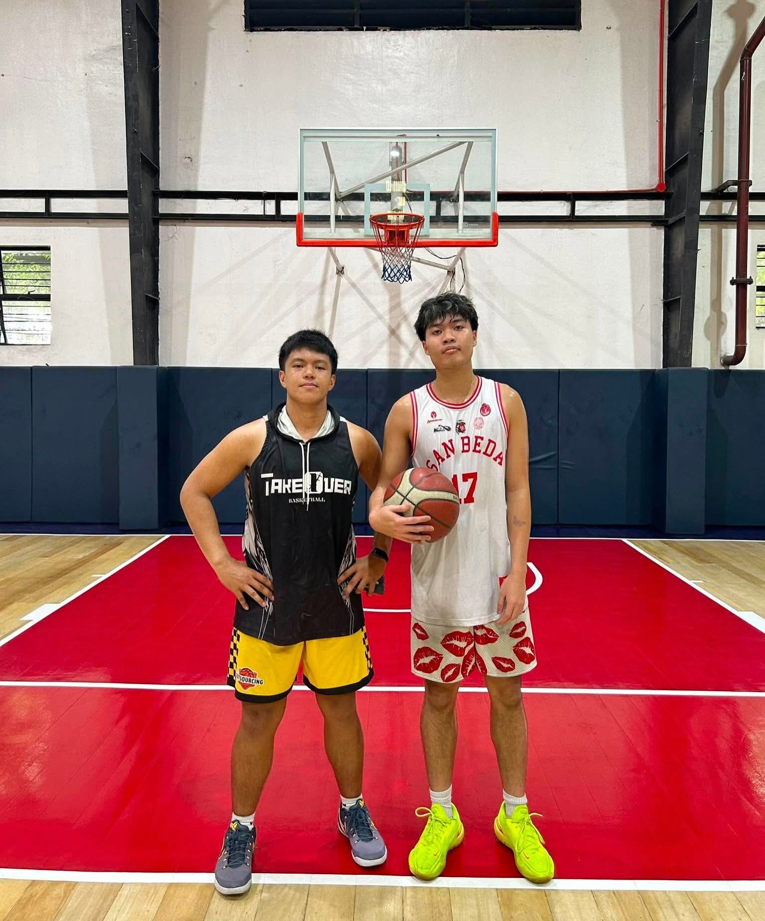 Players training at Takeover Basketball on a red and white court