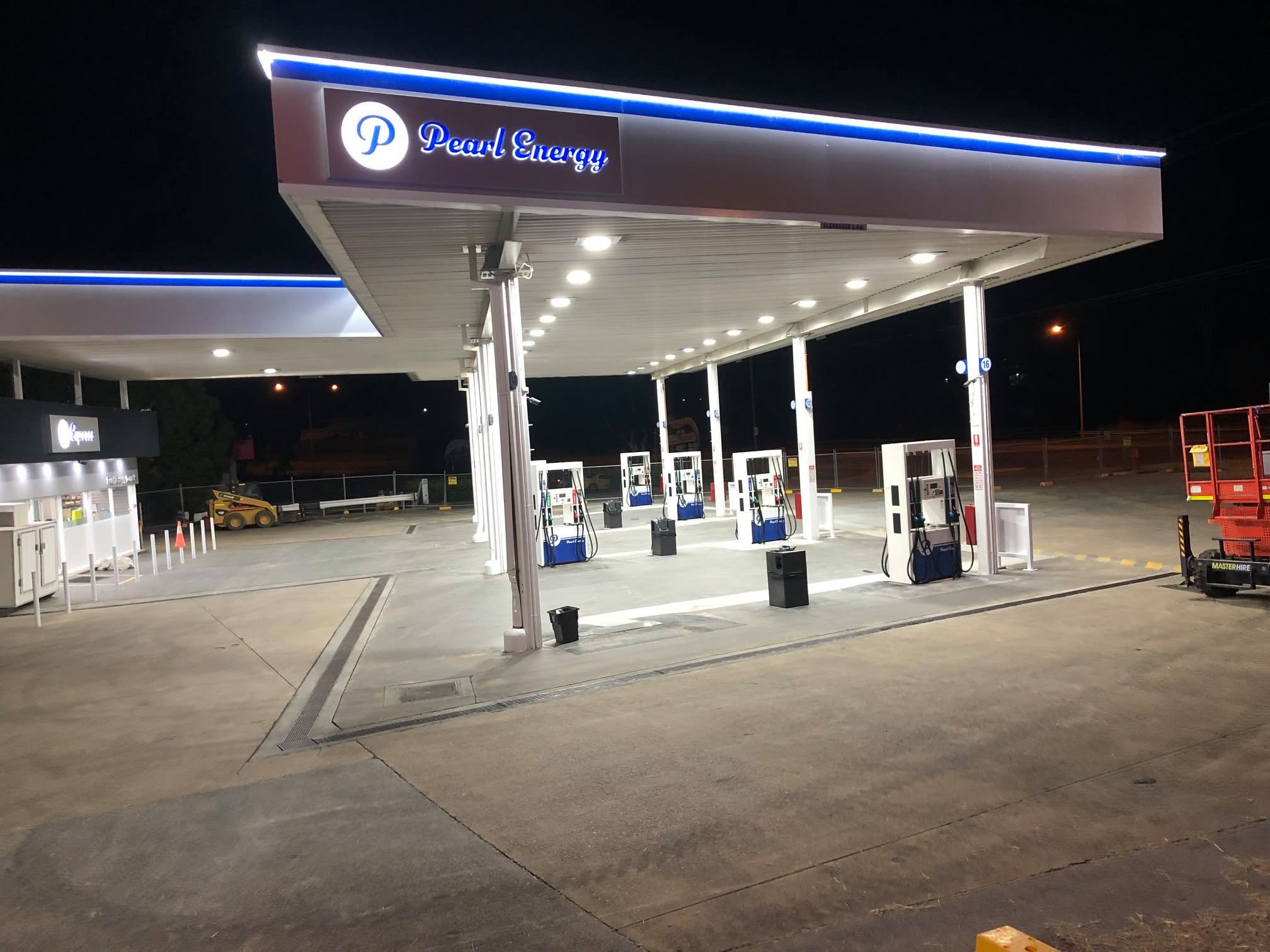 Pearl Energy illuminated canopy and fuel bowsers at night
