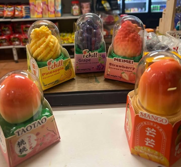 Colourful South Asian frozen ice cream treats on display including pineapple, grape, strawberry and mango flavours