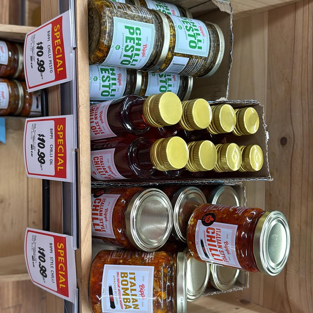 Specialty international condiment jars and sauces on a wooden shelf at SPAR