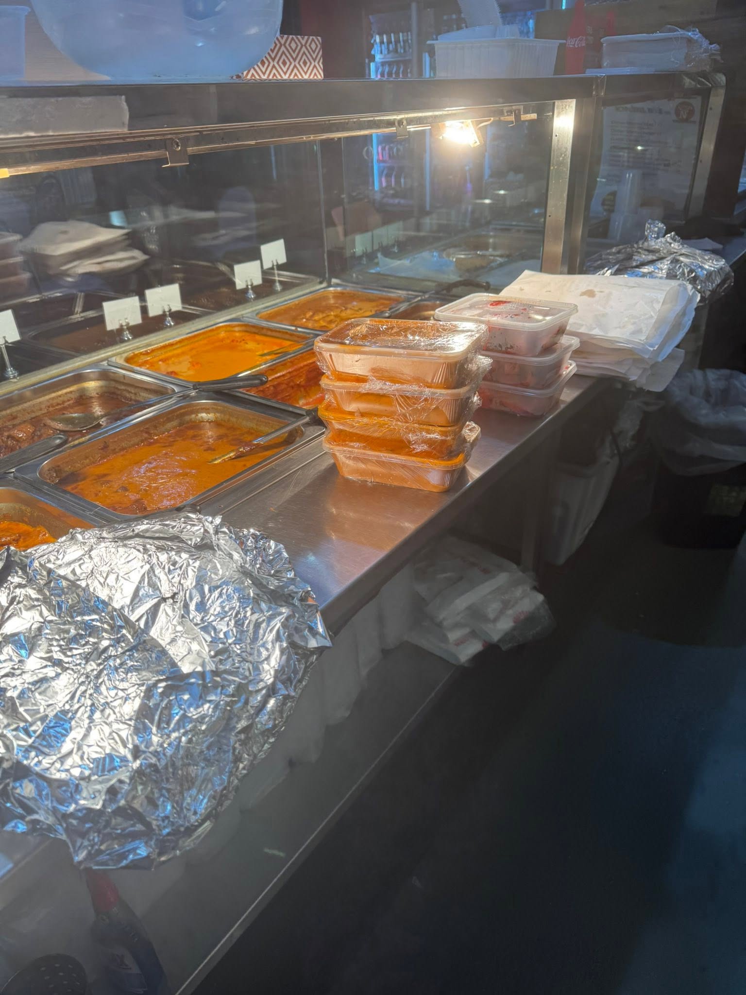 Fresh curries and naan bread packaged for takeaway at Nargis Indian & Kebab