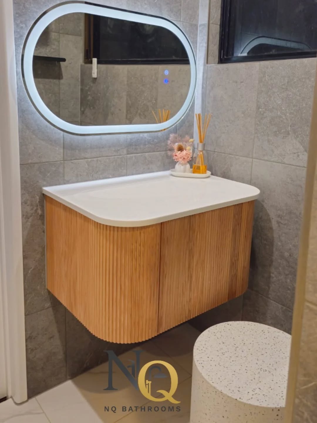 Modern floating vanity with LED mirror and grey stone wall tiles