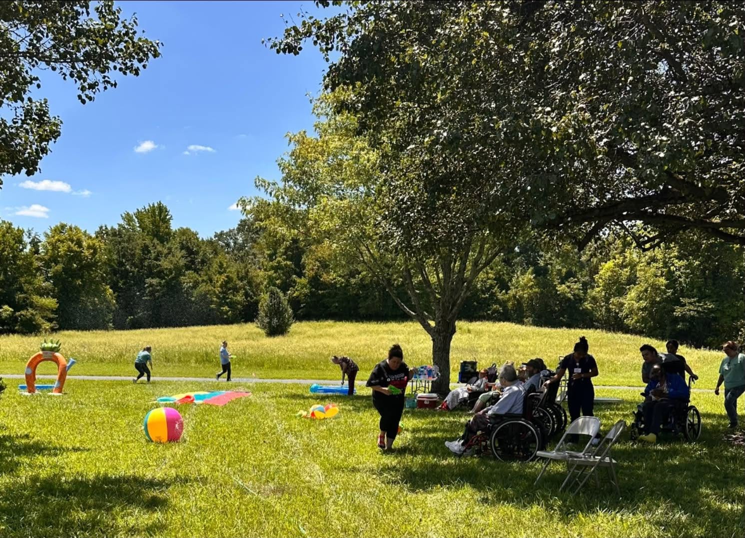 Ahava Services team engaging residents in outdoor therapy activities on a sunny day